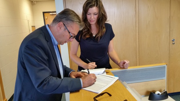 Mayoral candidate Don Zurowski files his nomination papers with Deputy Electoral Officer Deanna Wasnik as witness