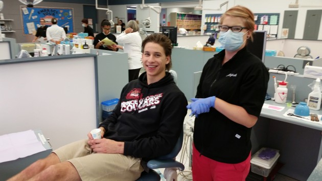 Second year dental hygiene student Alajiah DuBois prepares to fit PG Cougars defenceman Will Tomchuk with sport guard - photo 250 News