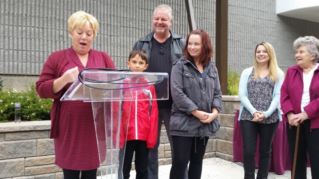 Terri McConnachie announces she's running for a council seat with her family standing behind her - photo 250 News