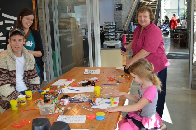 Sydney Turner creates a keyboard while Aunt Sandi looks on. Photos 250 News
