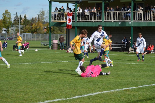 UNBC keeper Ty Venhola smothers ball at the feet of Spartans attacker