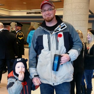 Shane Hartley & son Logan take in today's ceremony - photo 250 News