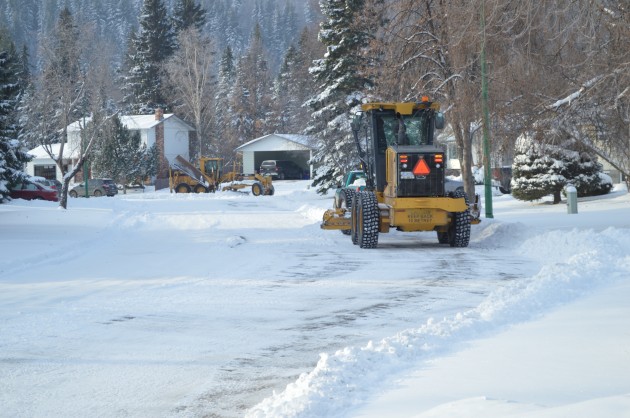 Graders clear residential street in Heritage area Sunday afternoon