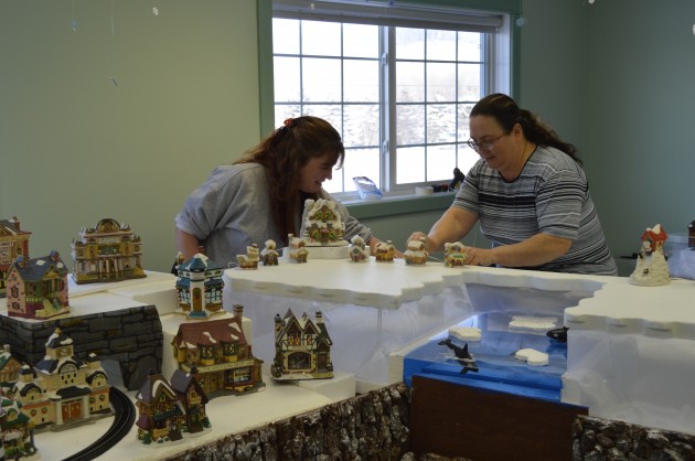 Kirsten Korte (left) and Lisa Smith hard at work on village display. Photo 250News