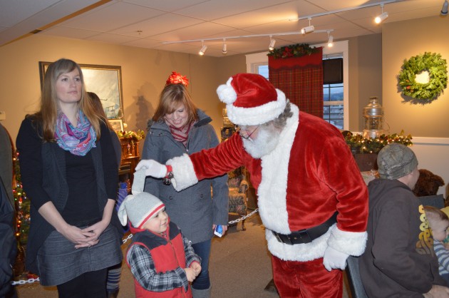 Santa asks youngster about his ears at Railway Museum party. 250News photos