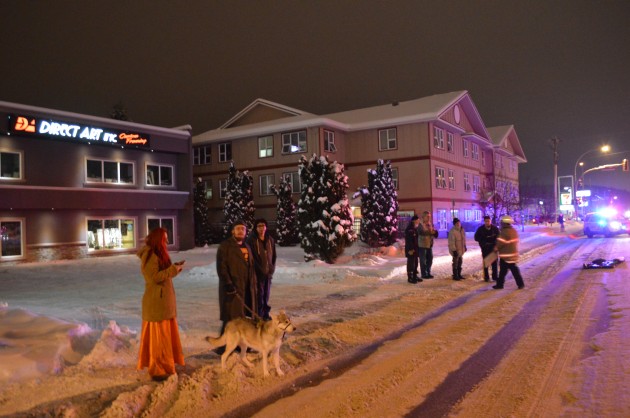 Building tenants look on from across Queensway