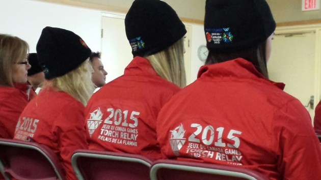 Torchbearers listen attentively to address by Sport Minister Coralee Oakes. Photo courtesy Canada Winter Games
