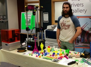 John Makowsky stands next to 3D printer