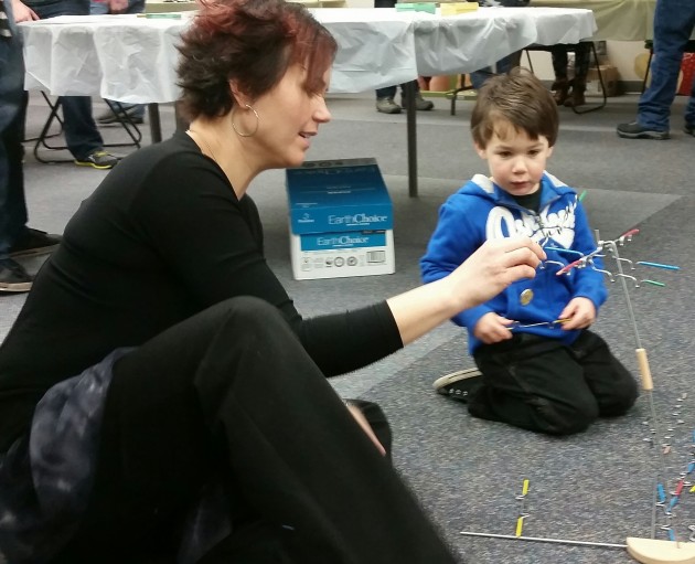 Masters student Jean Bowen demonstrates math activity to Sam Hannigan - Photo 250News