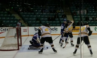 Team Manitoba and Team BC battle for the puck Monday night. Manitoba beat BC, 5-2. - photo 250News