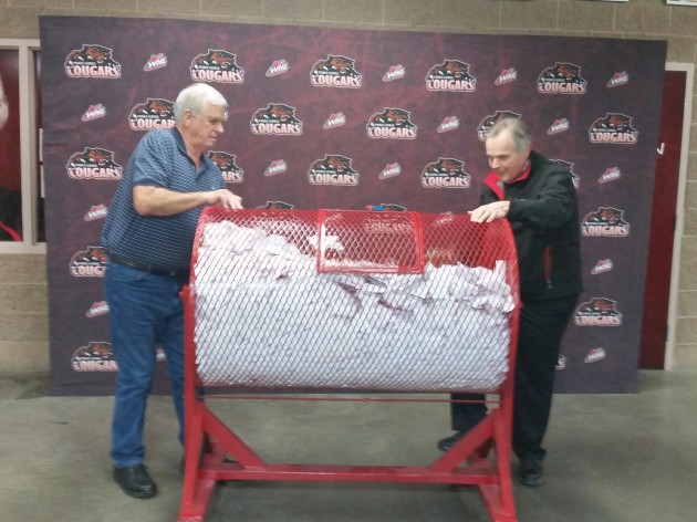 From left, Ken Sands, president of the Prince George Cougars 50/50 Society & Andy Beesley, Cougars vice-president of business, choose winning ticket - photo 250News
