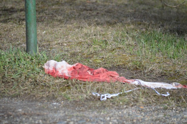 Apparently blood-soaked item lies beside street sign at 20th and Central Saturday afternoon. Photo 250 News