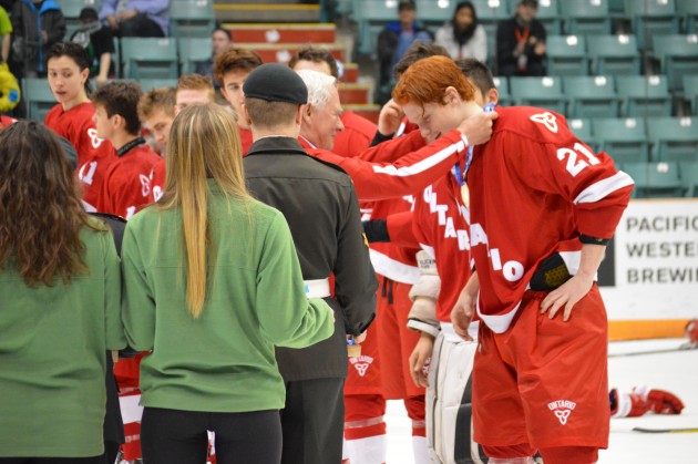 Governor General David Johnston places gold medal around neck of Ontario's Owen Tippett.