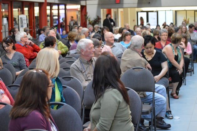 Crowd listeners to one of the many open mike speakers at education forum. Photo- 250News