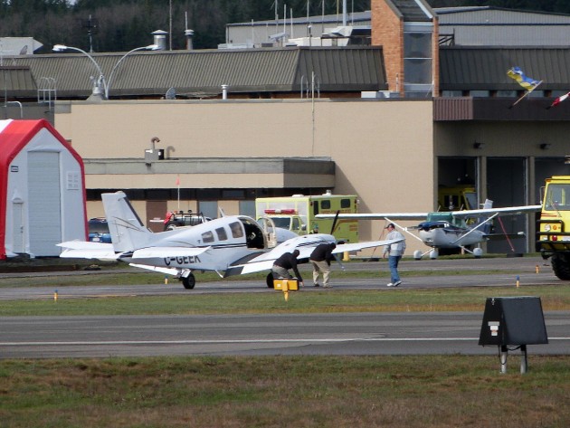 Pilot and airport personnel check cause of engine failure
