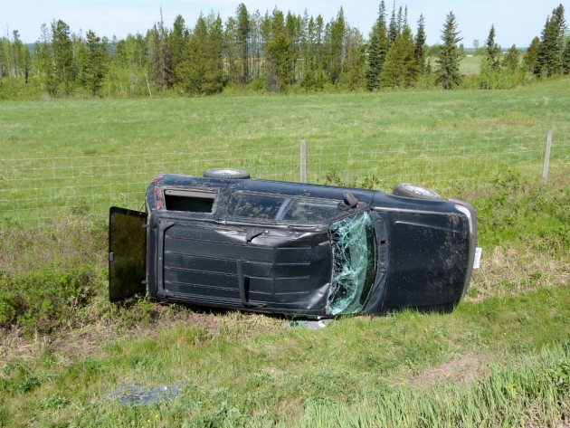 SUV rolled off Highway 97 and stopped next to wire fence south of Red Rock. Photos 250News