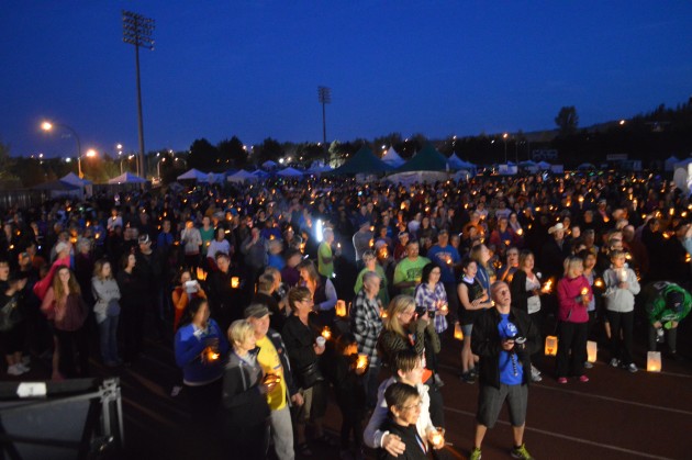 Participants raise their candles during Saturday night's Luminary Ceremony. Photo 250News