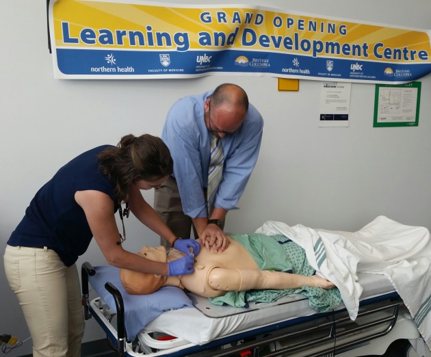 Dr. Heather Siemens and Dr. Robert Tower demonstrate simulator equipment
