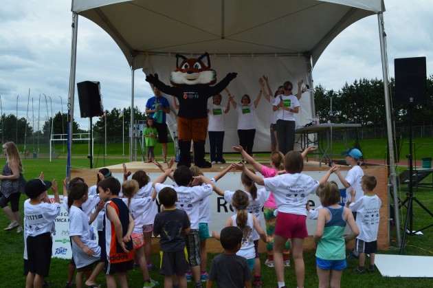 Nanguz warms up young runners prior to Healthy Kids Marathon Sunday. Photo 250News