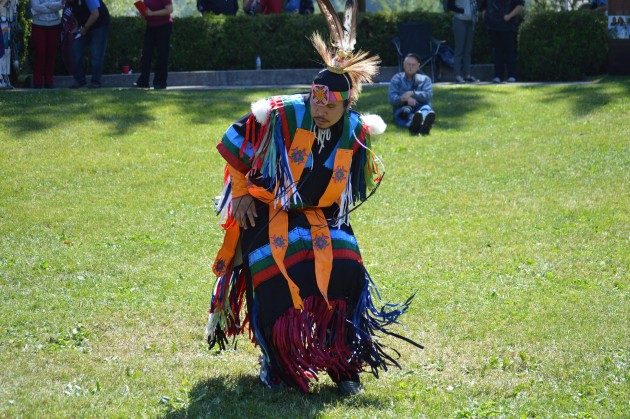Men's Grass Dancer Ken Michel, Jr. performs under sunny sky Sunday