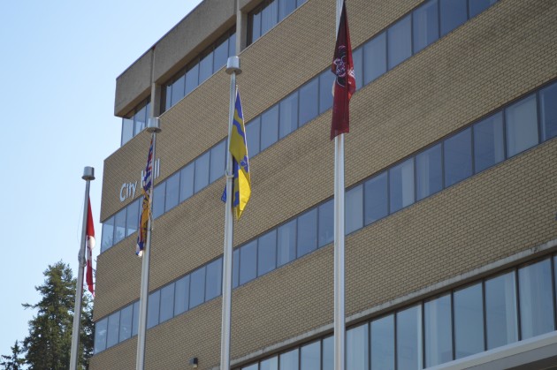 (r-l) Lheidli T'enneh flag, joins City of PG, BC and Canadian flags outside City Hall