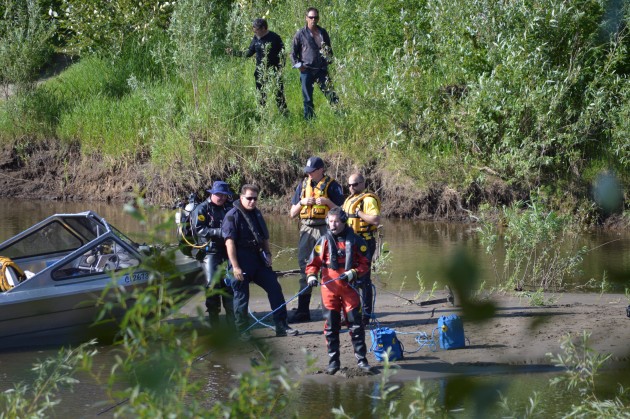 SAR and RCMP dive team work from sandbar as missing boy's father and uncle look on. Photos 250News
