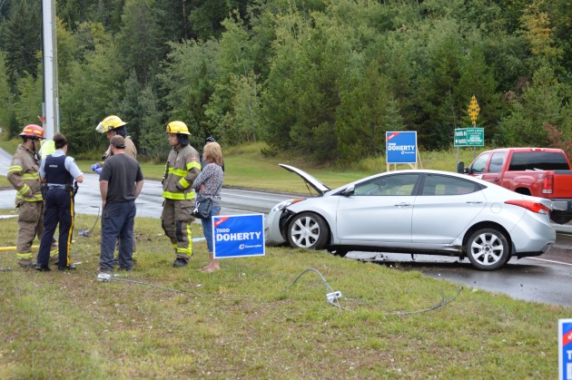 Guy-wire lays on ground after being snapped by car's impact