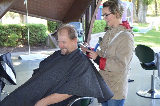Kelly Sheptak was the first to get his hair cut at the park, courtesy of Sky Petersen. 250News photo