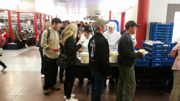 Long lineups for the "toonie barbecue" today - photos 250 News