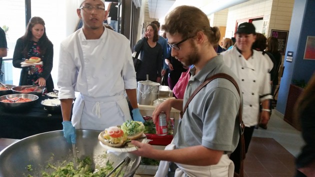 Computer Science student Vinicies Gigleano of Brazil tops up his plate