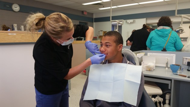 Second year dental student Chelsea Lestage custom fits Prince George Cougar player Kolby Johnson - photos 250 News