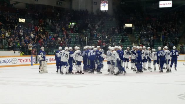 Canucks players wave their sticks to the fans following the end of camp today - photos 250 News