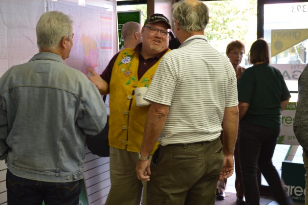 Green candidate Richard Jaques (centre) talks with supporters Saturday. Photo 250 News