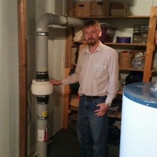 Fudge stands next to his radon mitigation pump