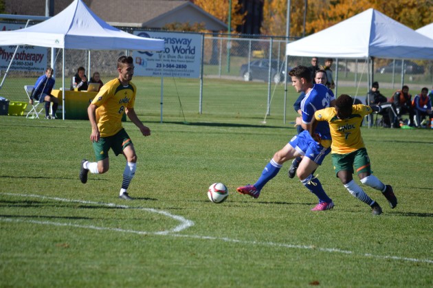 UBC (blue) attacks the Timberwolves' box during first half action Saturday. Photo 250 News