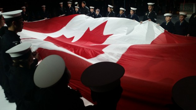 The Aurora Navy League Cadets hold the flag during opening ceremony
