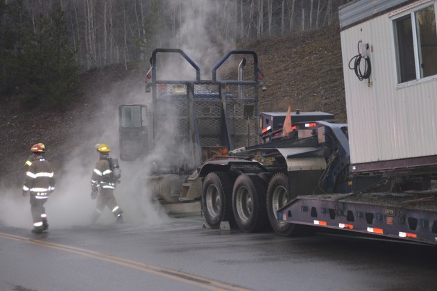 Firefighters use extinguishers to ensure truck fire is out. Photos 250News