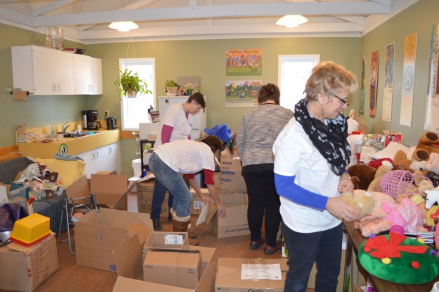 Volunteers were busy boxing toys at REAPS office on Saturday. Photo 250 News