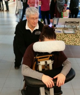 Massage therapist Kathy Baker works on 2nd year student Emily Carter