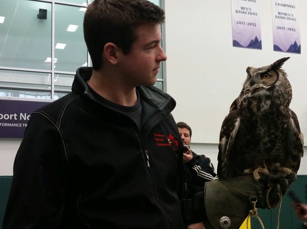 Bailey Wood of The Canadian Raptor Conservancy holds Toba, a Great Horned Owl - photos 250News