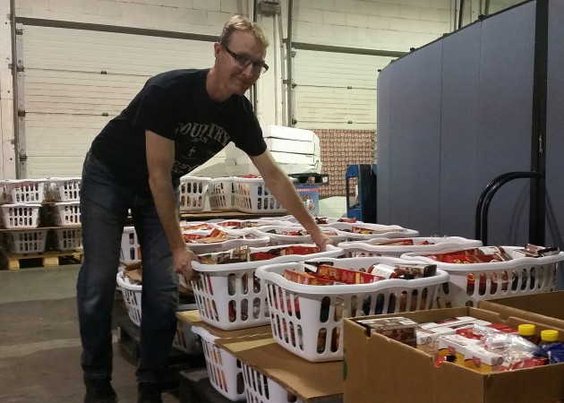 Roy Law, Community Ministries Director with the Prince George Salvation Army, holds one of 400 Christmas hampers - photos 250News