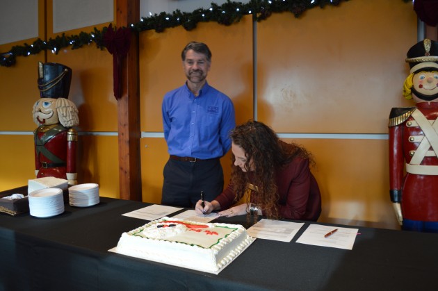 Science World CEO Bryan Tisdale looks on as Exploration Place CEO Tracy Calogheros signs MOU. Photo 250News