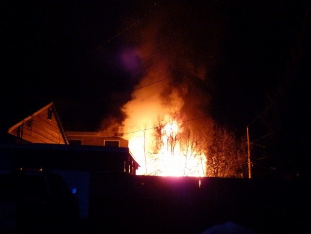 Flames shoot from rear of residential building on South Kelly Street. Photo 250 News