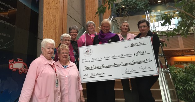 Spirit of the North CEO Judy Neiser (centre) receives cheque from Auxiliary members