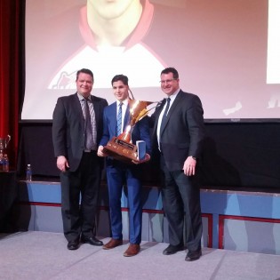 Coach Mark Holick and GM Todd Harkins pose with MVP winner Chase Witala