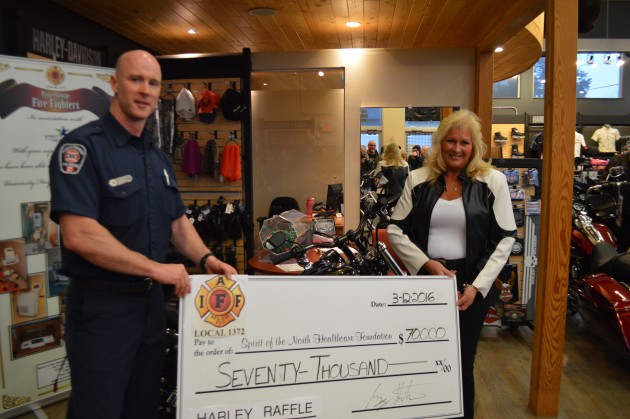 Firefighters Harley committee chair Greg Houston presents $70,000 cheque to Healthcare Foundation CEO Judy Neiser