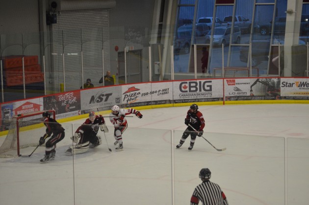 Cariboo Cougars' Riley Coish watches rebound of his shot go into net off defender for Cat's first-period goal Friday. Photo 250 News