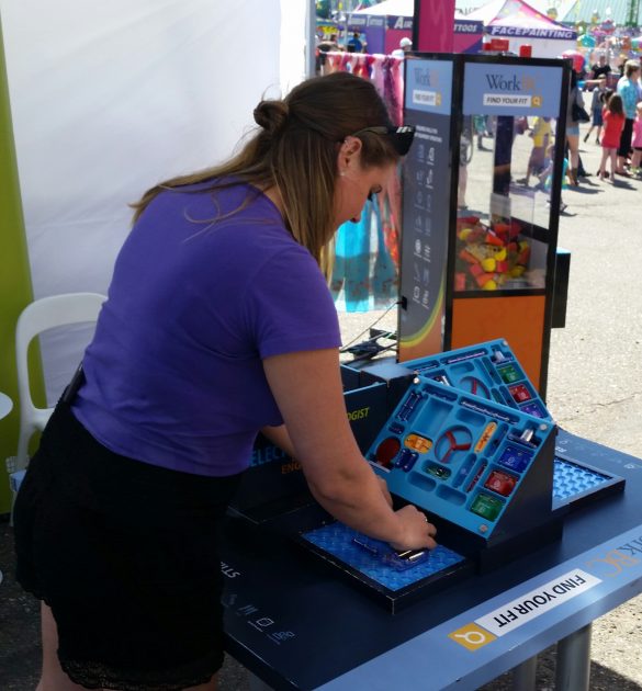 Jessica Giles, Tour Supervisor with the Find Your Fit Tour, at the electronics technician table - photo 250News