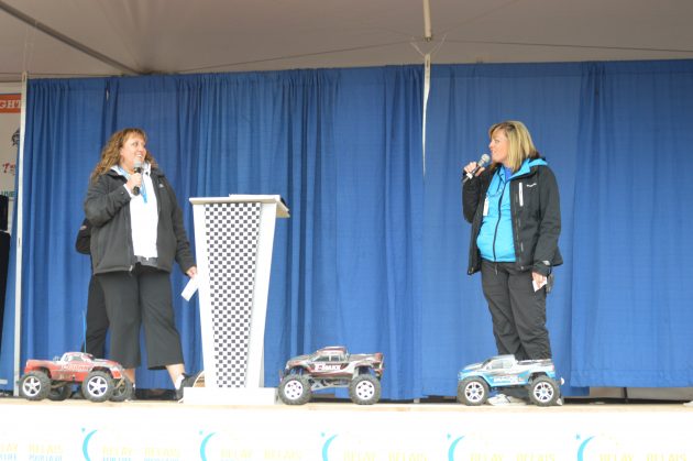 Relay co-ordinator Aimee Cassie (r) gives co-chair Melanie Blake the fundraising total Sunday morning. Photos 250News