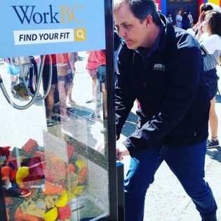 Reporter Greg Fry tries out the heavy equipment operator simulator - photos 250News